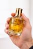 One Billionaire perfume bottle in hand